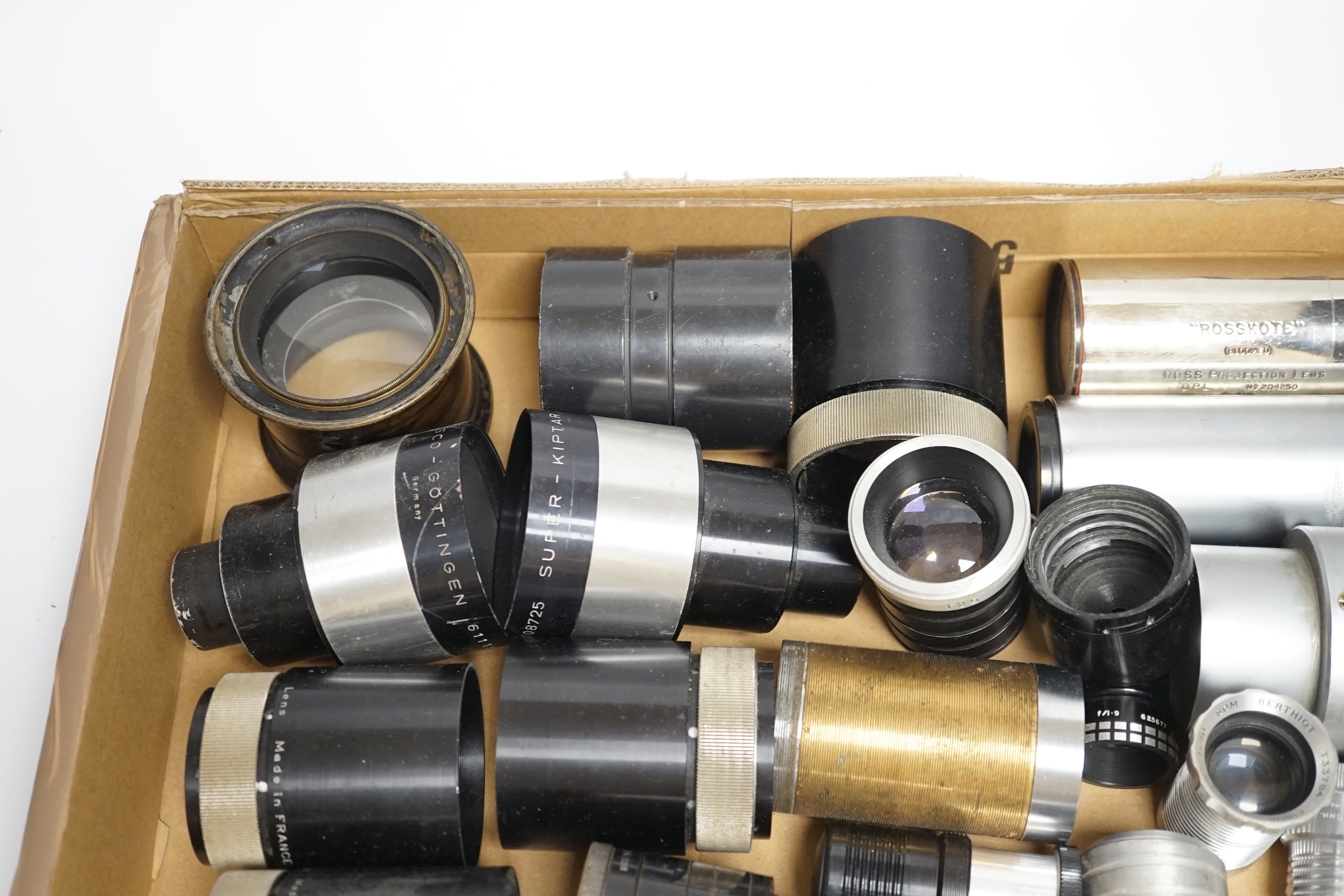 A collection of vintage cine camera lenses including examples by Taylor-Hobson, Super Six, Berthiot, Isco-Gotingen, Eumig, Ross, Gaumont Kalee, Aldis, etc.